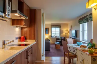 a kitchen and living room with a kitchen and a living room at 12 Ullswater Suite - Whitbarrow Village in Penruddock
