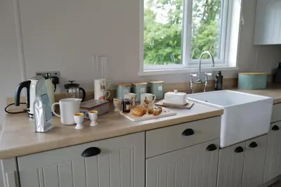 a kitchen counter with a sink and some food on it at Snittlegarth Farm Lodges in Wigton