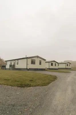 a large white building on the side of a road at Snittlegarth Farm Lodges in Wigton