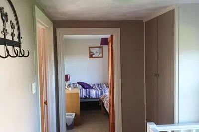 a room with a bedroom with a bed in it at Pinfold Cottage on the edge of lake district in Bothel