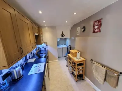 a bathroom with blue counter tops and a sink at Pinfold Cottage on the edge of lake district in Bothel