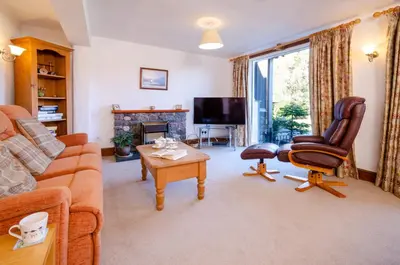 a living room with a couch and a chair at Bens Cottage in Chapel Stile