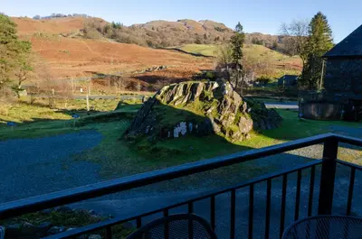a balcony with a view of a rock formation at Bens Cottage in Chapel Stile