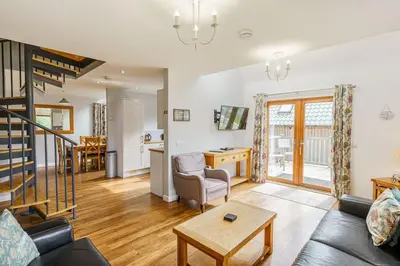 a living room with a couch and a table at Lord Galloway 33 with Hot Tub in Newton Stewart