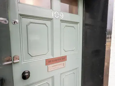 a door with a sign that reads the do not enter sign at The Old Betting Shop in Keswick