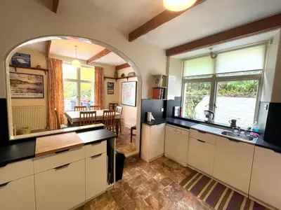 a kitchen with a large window and a dining room at Beautiful 4BR Period Home With Spectacular Views - Pass the Keys in Kippford