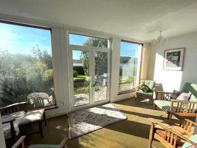 a living room with large windows and a view of the water at Beautiful 4BR Period Home With Spectacular Views - Pass the Keys in Kippford