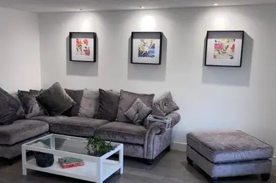 a living room with a couch and a coffee table at Stunning Refurbished 1 Bedroom, Harbour Apartment. in Ayr