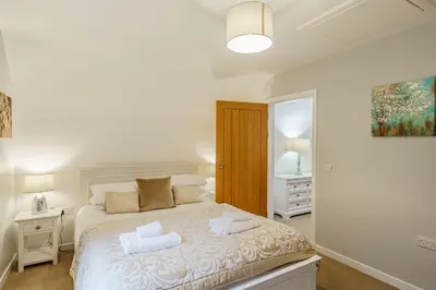 a bedroom with a bed with two towels on it at Lord Galloway 35 with Hot Tub in Newton Stewart