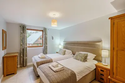 a bedroom with two beds and a window at Lord Galloway 35 with Hot Tub in Newton Stewart