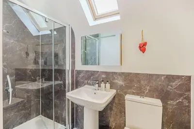 a bathroom with a sink and a shower and a toilet at Lord Galloway 35 with Hot Tub in Newton Stewart