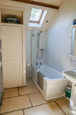 a bathroom with a bath tub and a sink at Beckside Cottage, near Carlisle romantic cottage with hot tub in Longtown