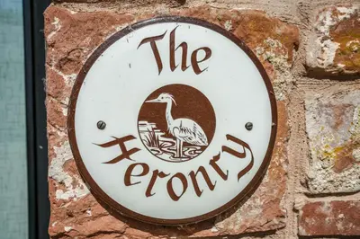a sign for the town on a brick wall at The Heronry, Netherby, a luxurious cottage ideal for a romantic break with hot tub in a rural setting in Longtown