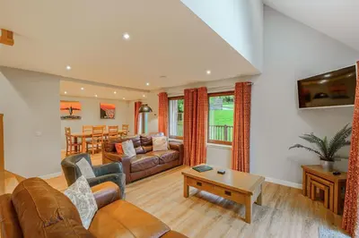 a living room with a couch and a table at Lord Galloway 36 with Hot Tub in Newton Stewart
