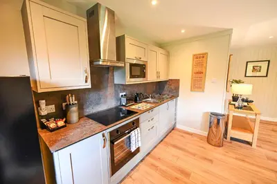 a kitchen with a sink and a counter top at Bluebell Lodge 2 with Hot Tub in Newton Stewart