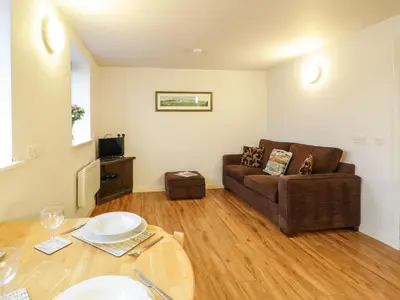 a living room with a couch and a table at Tides Reach in Newton Stewart