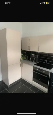 a kitchen with white cabinets and a stove top oven at Elegant bungalow in Newmilns, East Ayrshire in Newmilns