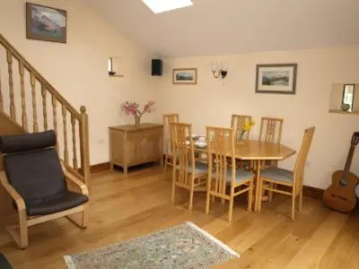 a dining room with a table and chairs at Damson Ghyll B&B in Loweswater