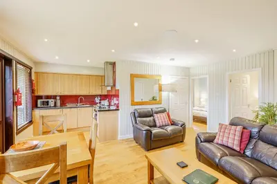 a living room with a couch and a table at Birch Lodge 19 with Hot Tub in Newton Stewart