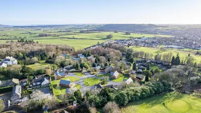 an aerial view of a village with houses and trees at Birch Lodge 22 with Hot Tub in Newton Stewart