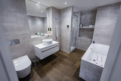 a bathroom with a toilet and a sink and a shower at Shore Hotel Laxey in Laxey