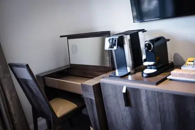 a coffee machine sitting on a desk with a chair at Shore Hotel Laxey in Laxey