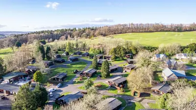 an aerial view of a village with houses and trees at Birch Lodge 16 in Newton Stewart