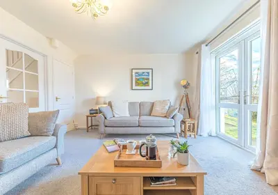 a living room with a couch and a coffee table at Lilac Cottage in Keswick