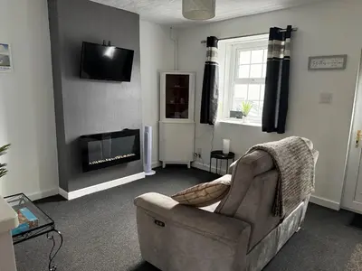 a living room with a couch and a fireplace at 16 Main Street in St Bees