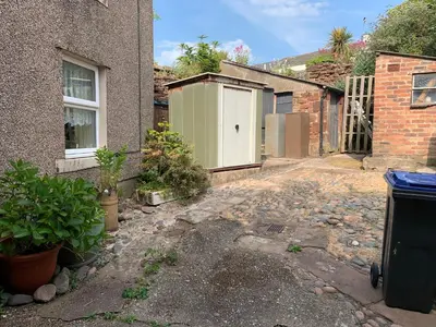 a house with a white door and a building at 16 Main Street in St Bees