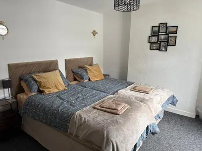 a bedroom with a bed with two pillows on it at 18 Main Street in St Bees