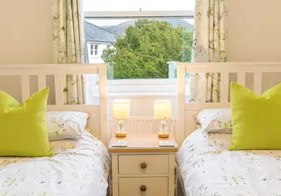 two twin beds in a bedroom with a window at Felltops in Keswick