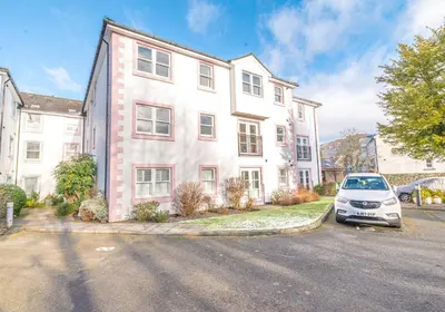 a white car parked in front of a house at 16 Greta Grove House in Keswick