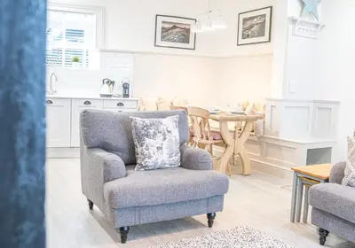 a living room with a chair and a table at Brandelhowe in Keswick