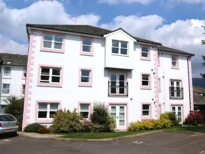 a large white house with a car parked in front of it at Latrigg View in Keswick