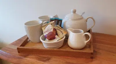 a wooden tray with tea pots and cups on a table at Skiddaw. 20 Greta Grove House in Keswick