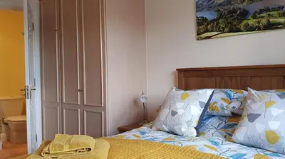 a bedroom with a bed with a hat on it at Skiddaw. 20 Greta Grove House in Keswick