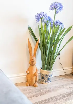 a statue of a rabbit next to a vase of flowers at Tiggs Place, 5 Howrahs Court in Keswick