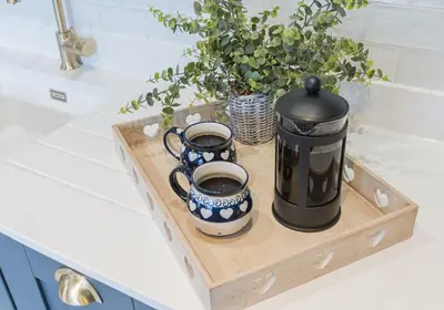 a tray with two cups and a coffee pot on a counter at Withesike, Derwent House in Keswick