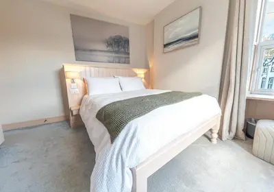 a bedroom with a large white bed with two pillows at Withesike, Derwent House in Keswick