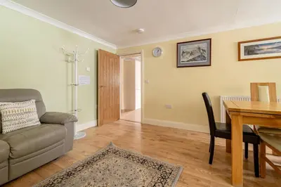 a living room with a couch and a table at The Blue House holiday home in Egremont