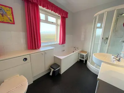 a bathroom with a tub and a toilet and a sink at Beautiful Period Property in Central Location - Pass the Keys in Maxwelltown