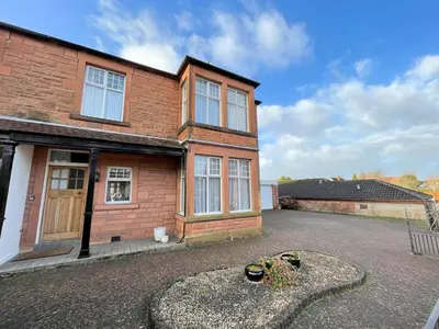 a brick house with some plants in a driveway at Beautiful Period Property in Central Location - Pass the Keys in Maxwelltown