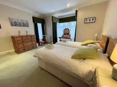 a large bedroom with two beds and a dresser at Beautiful Period Property in Central Location - Pass the Keys in Maxwelltown
