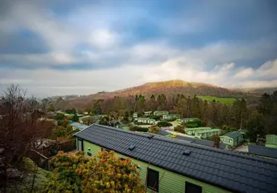 a view of a town with a mountain in the background at Beautiful 2BR In Kippford With Incredible Views - Pass the Keys in Palnackie
