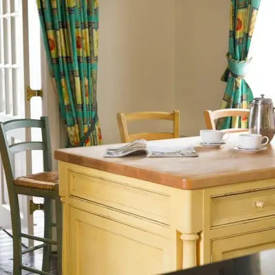 a kitchen with a table with two cups and chairs at Bramrigg House in Grasmere