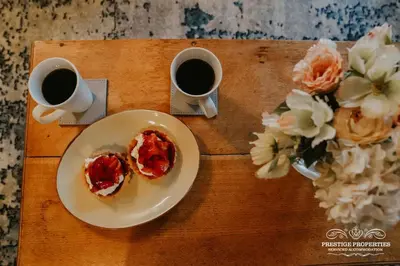 a table with two plates of food and two cups of coffee at Pine lodge by Prestige Properties SA in Seascale