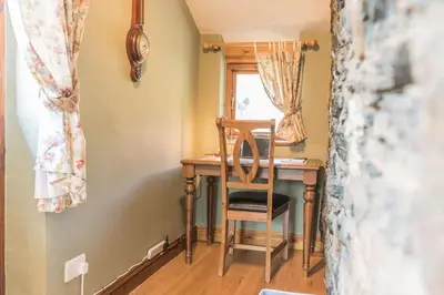 a desk in a room with a chair and a window at Slater Bob's Coppermines Valley in Coniston