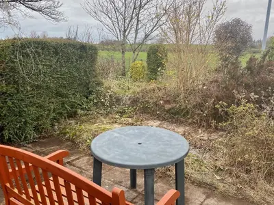 a table sitting next to a bench next to a table at lake District cottage in Bootle