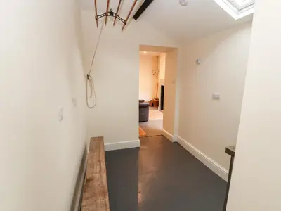a hallway with white walls and a ceiling at Cobbleken in Cockermouth